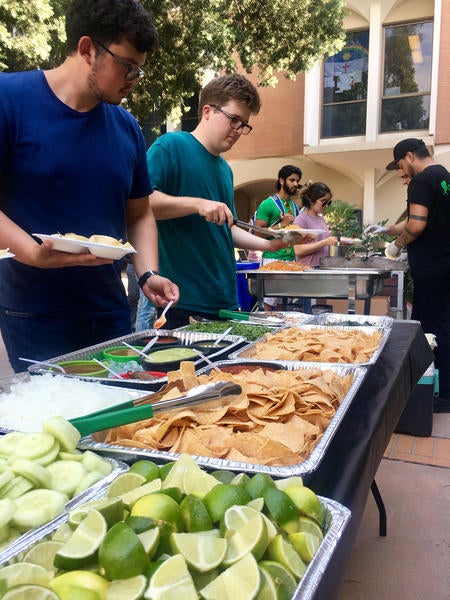 four students in a buffet line